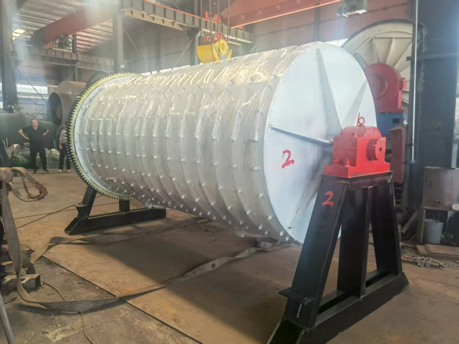 Large rotary cobblestone polishing drum showing ring gear and reducer drive